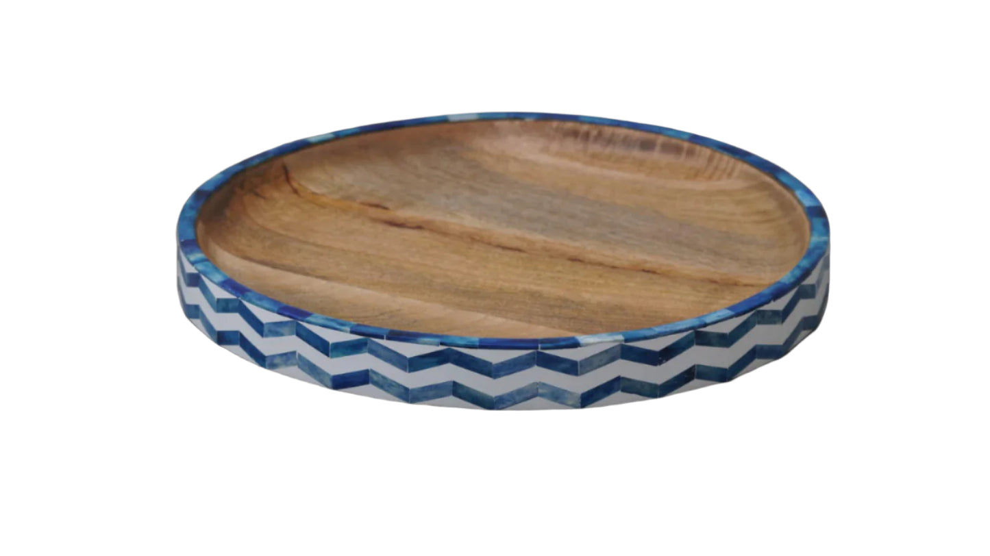 Wooden tray with blue and white zigzag pattern on a black background