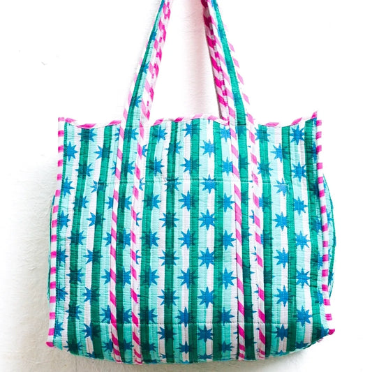 Tote bag with green and blue striped pattern on a white background