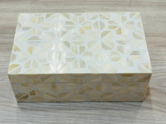 Decorative box with geometric pattern on a wooden surface
