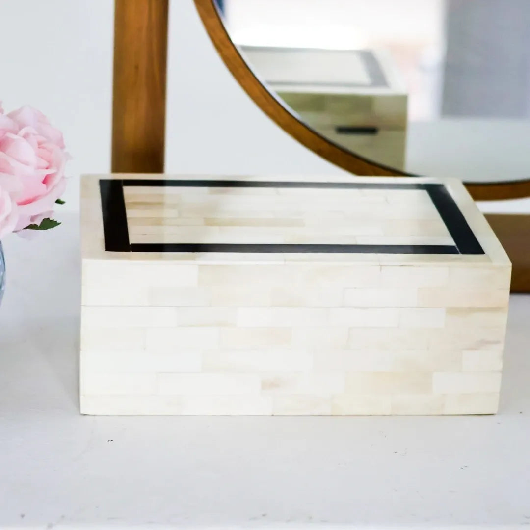 Wooden jewelry box with a mirror in the background