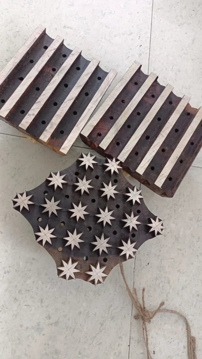 Wooden block with star patterns on a light gray surface