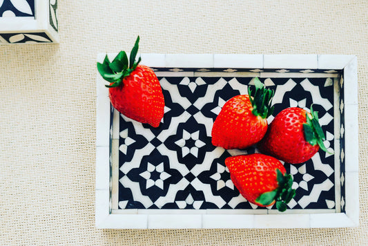 Strawberries on a decorative tray with a geometric pattern