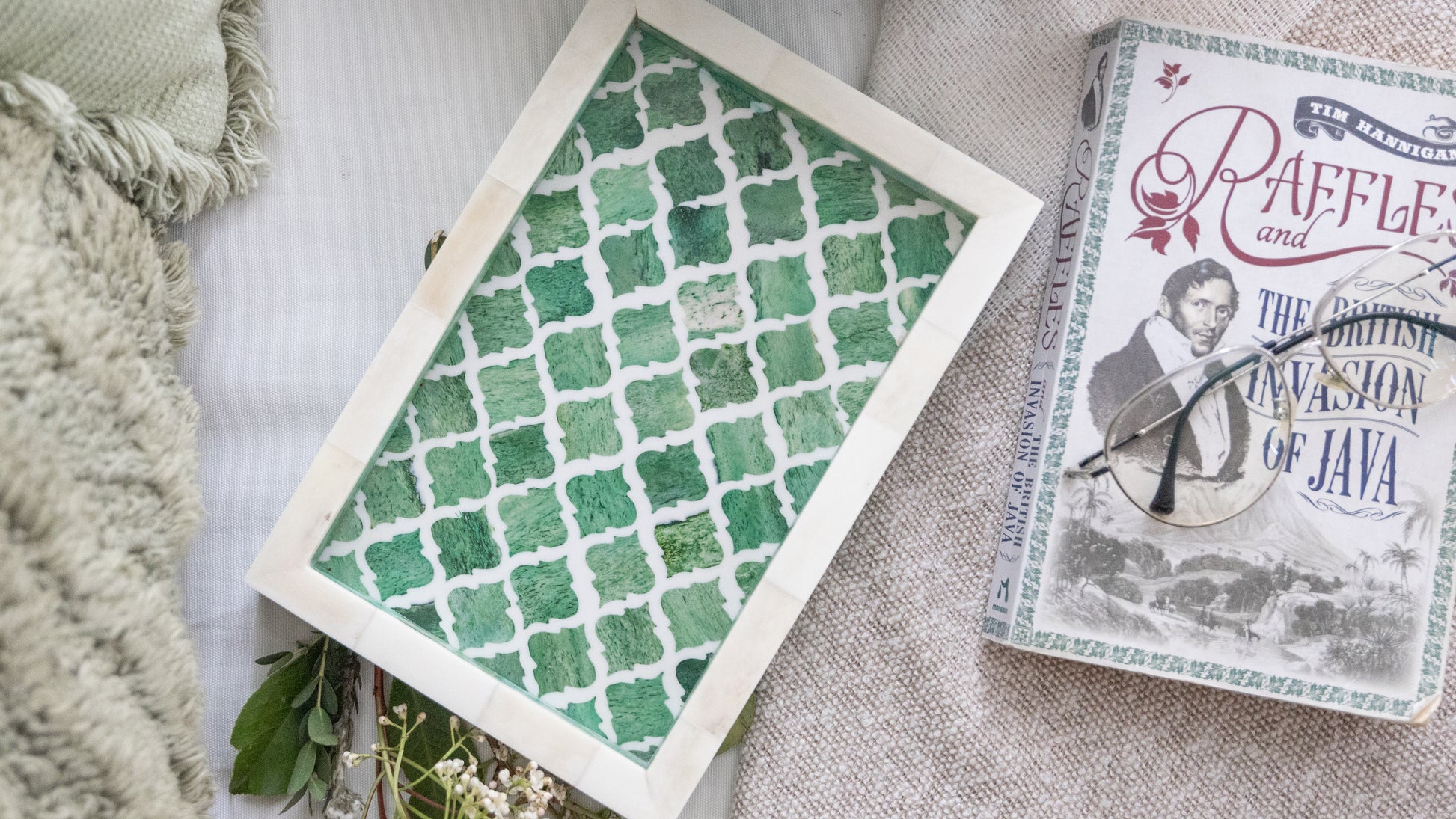 Book titled 'Raffles and the British Invasion of Java' with a green patterned card on a textured surface.