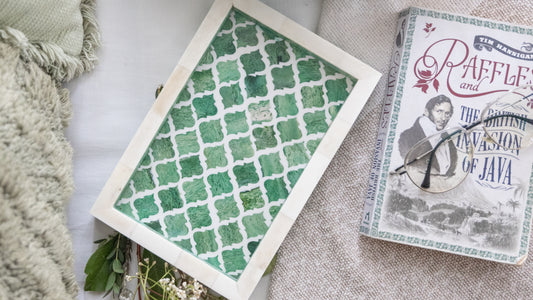 Book titled 'Raffles and the British Invasion of Java' with a green patterned card on a textured surface.