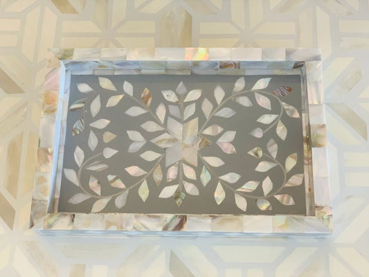 Decorative tray with leaf pattern on a textured surface