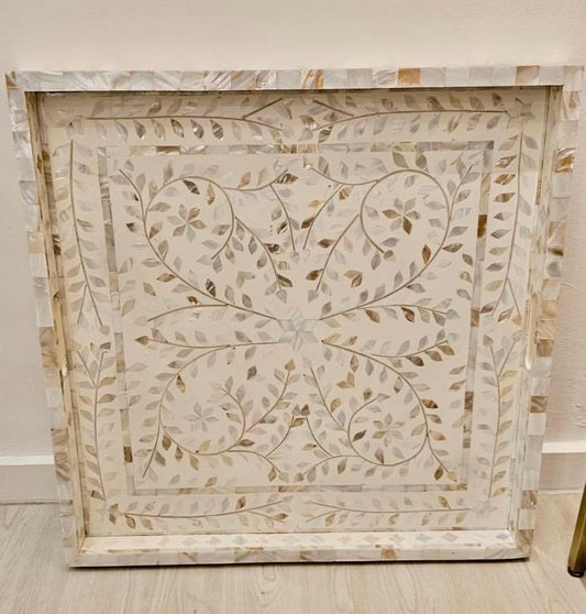 Decorative TRAY with intricate leaf pattern on a light background