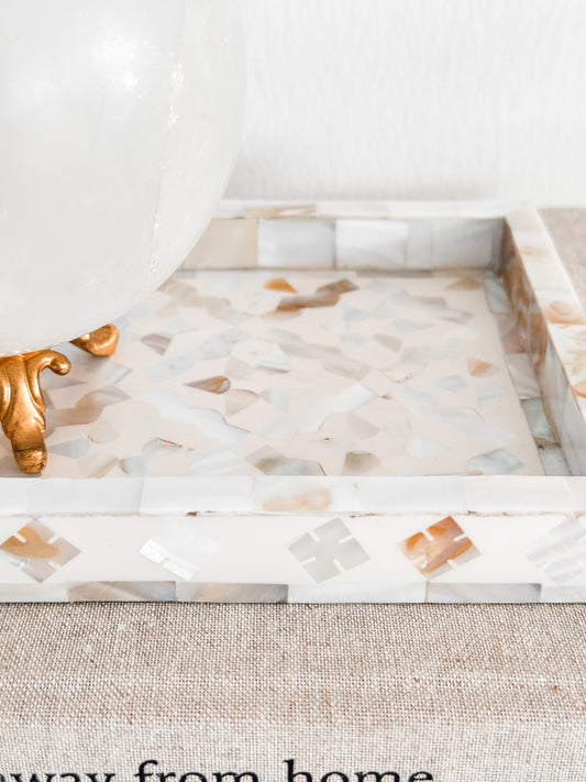 Decorative tray with marble-like pattern on a textured surface
