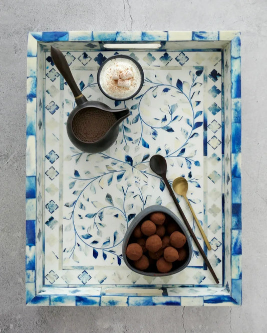 decorative tray in blue and white featuring chocolate and golden spoons