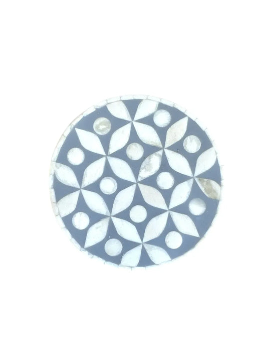 Round grey and white patterned coaster on a white background
