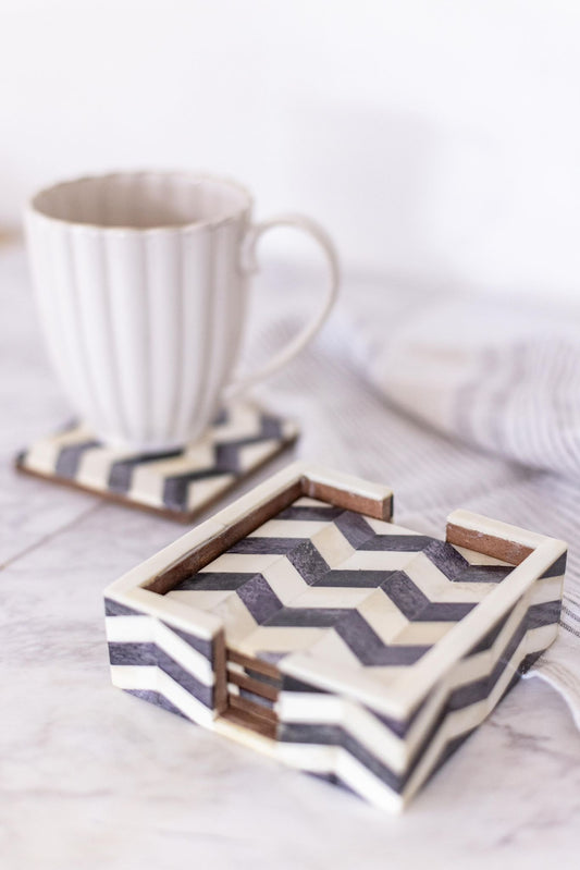 Chevron patterned coaster set with a mug on a light surface