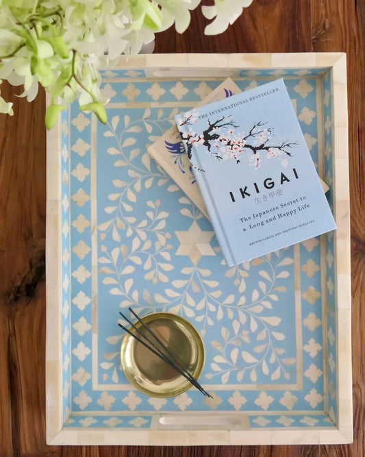 Book titled 'Ikigai' on a decorative tray with floral elements
