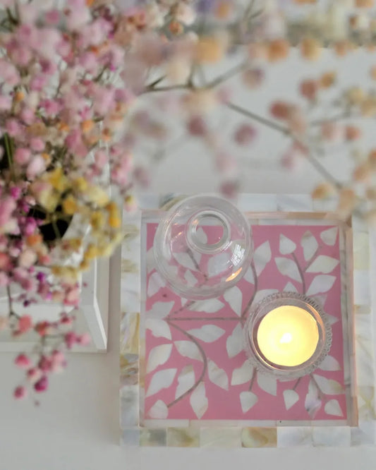 Decorative candle holder with floral design and pink background