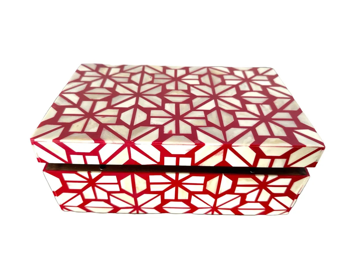 Decorative box with red and white geometric pattern on a white background