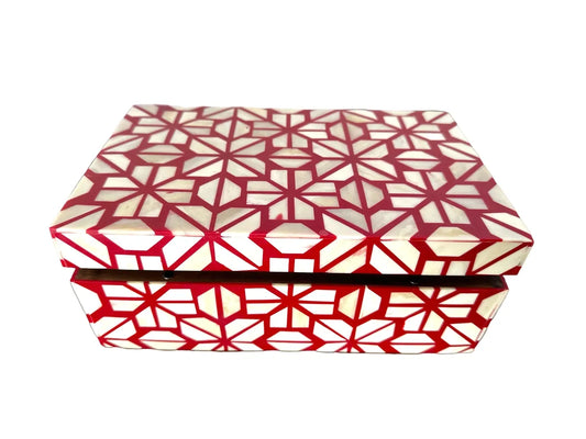 Decorative box with red and white geometric pattern on a white background