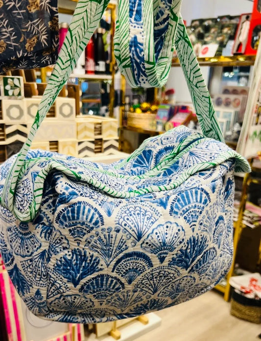 Blue and green patterned bag in a store setting