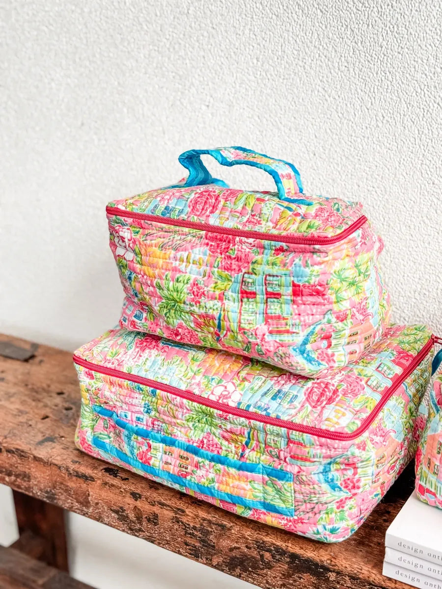 Two colorful fabric bags on a wooden surface with a white wall background