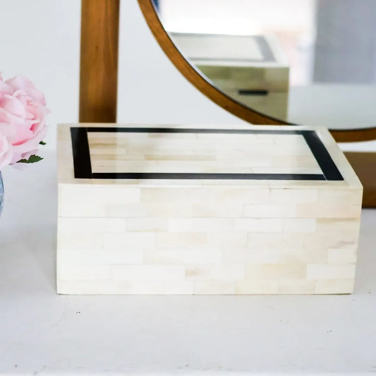 Wooden jewelry box with a mirror in the background
